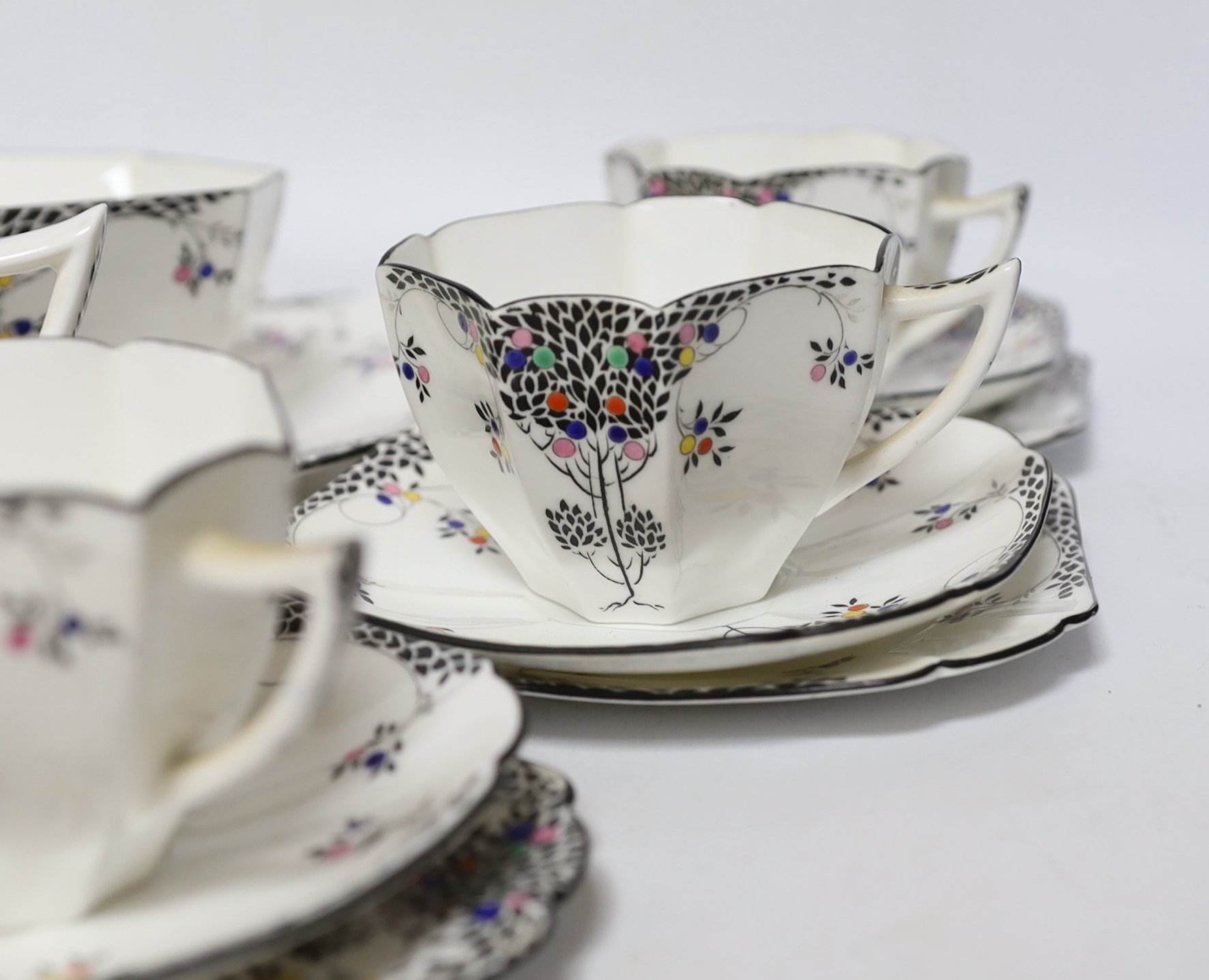 A Shelley Black Leafy Tree pattern part tea set comprising trios, milk jug, bowl and sandwich plate